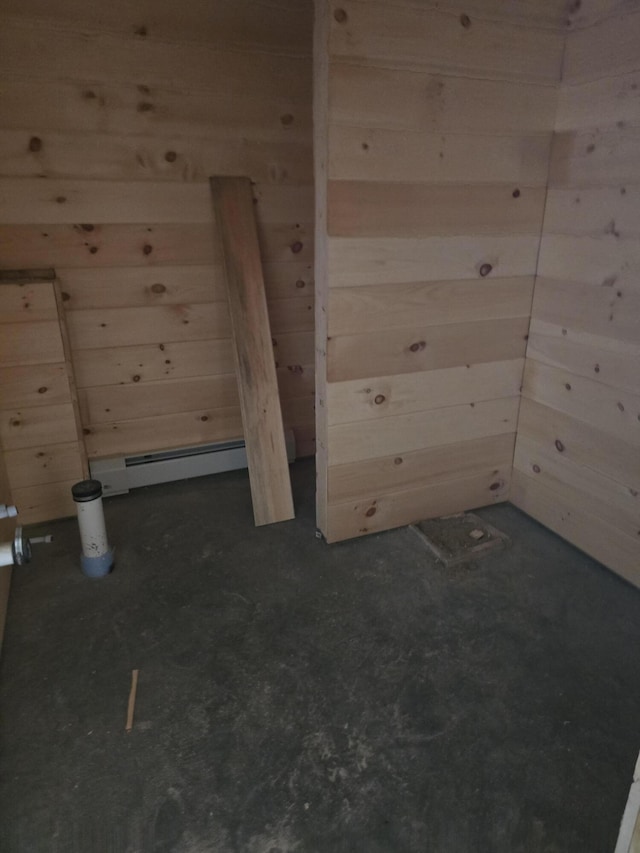 bonus room featuring wooden walls and baseboard heating