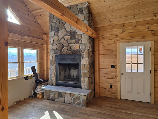 unfurnished living room featuring wooden ceiling, wood finished floors, vaulted ceiling, wood walls, and a fireplace