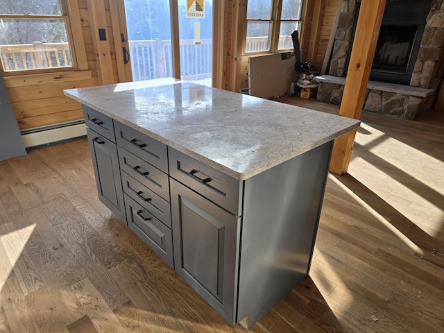 kitchen with a baseboard heating unit, gray cabinetry, and dark wood-style floors