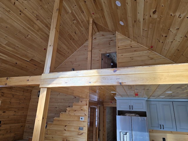 details featuring wooden walls, wood ceiling, fridge with ice dispenser, and beam ceiling