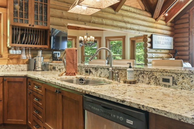 kitchen with light stone counters, dishwasher, lofted ceiling with beams, and a sink