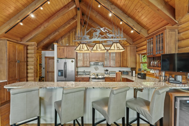 kitchen featuring lofted ceiling with beams, wood ceiling, appliances with stainless steel finishes, and brown cabinetry