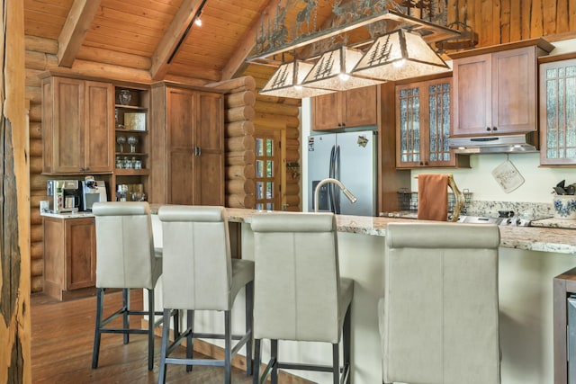 kitchen with vaulted ceiling with beams, open shelves, freestanding refrigerator, wood ceiling, and under cabinet range hood