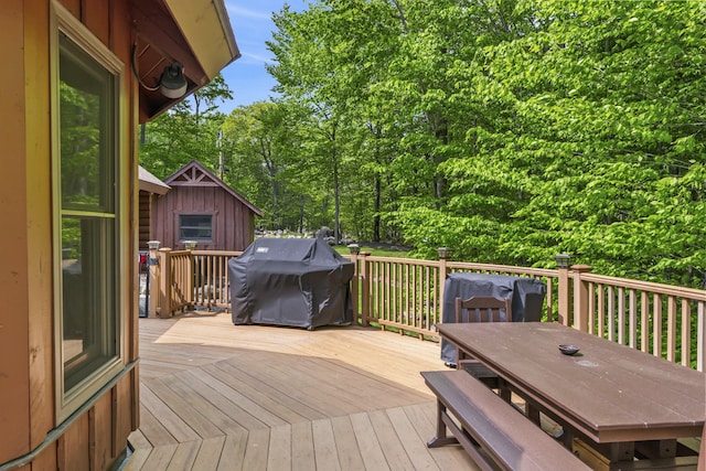 deck with outdoor dining space and a grill