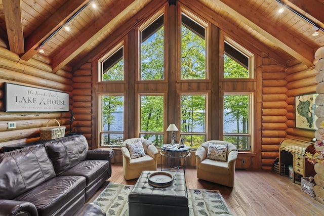 living room with wooden ceiling, a healthy amount of sunlight, beamed ceiling, and hardwood / wood-style flooring