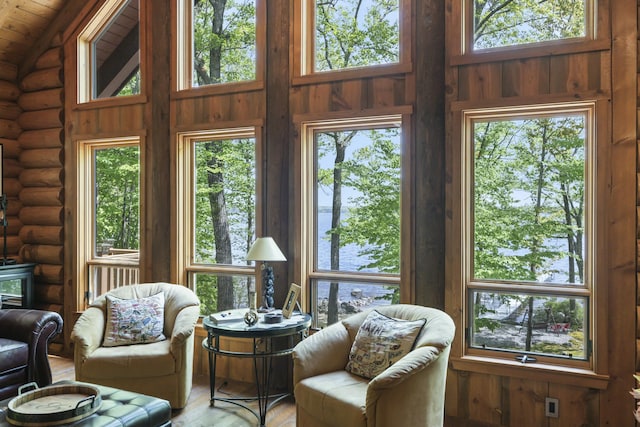 sunroom featuring lofted ceiling, wooden ceiling, and a wealth of natural light