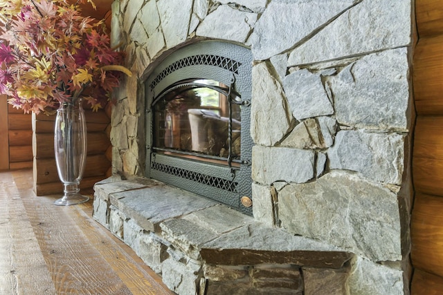 room details featuring log walls and wood finished floors