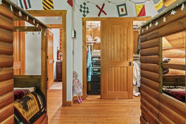 interior space with rustic walls and wood finished floors