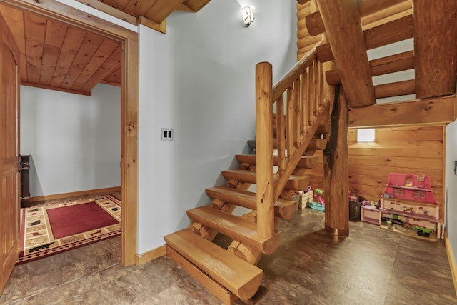 staircase with arched walkways, wood ceiling, and baseboards