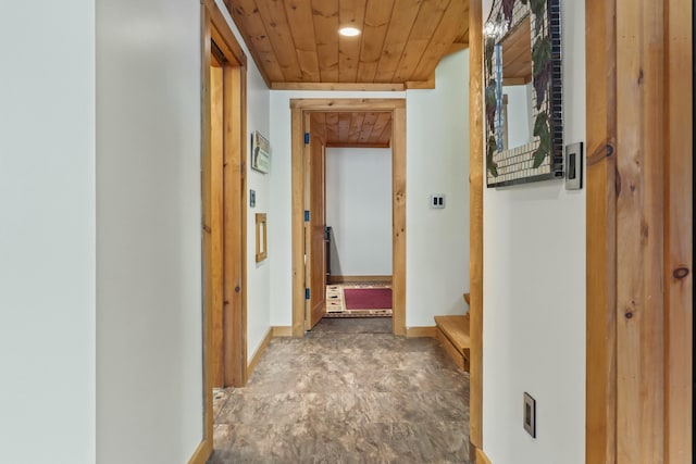 hall featuring wooden ceiling, stairway, and baseboards