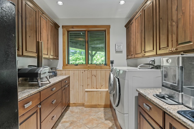 laundry area with recessed lighting, laundry area, light tile patterned flooring, and washing machine and clothes dryer