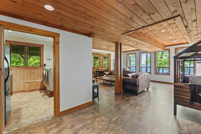 living room featuring recessed lighting, independent washer and dryer, wooden ceiling, and baseboards