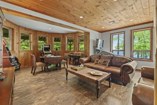 living room featuring visible vents, wood walls, wood ceiling, and crown molding