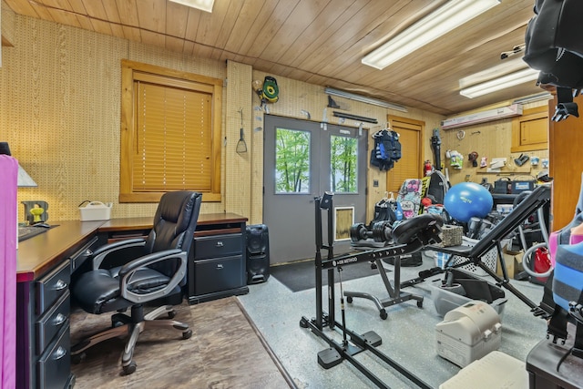 interior space with wood ceiling, a workshop area, and wallpapered walls