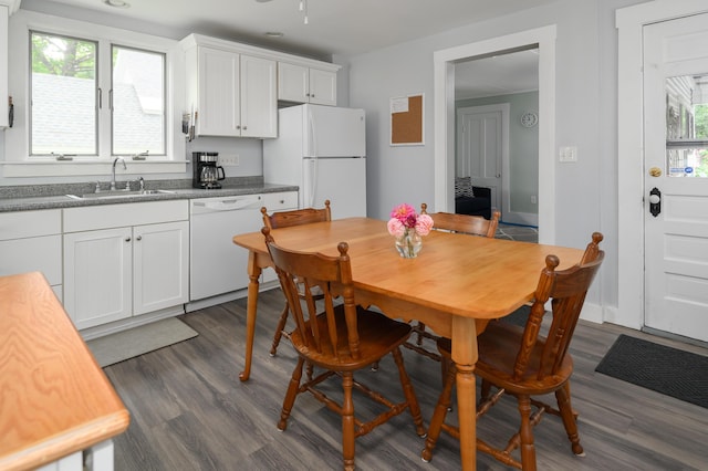 kitchen with dark wood-style floors, white appliances, a sink, and white cabinetry