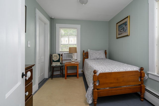 bedroom featuring cooling unit and baseboard heating