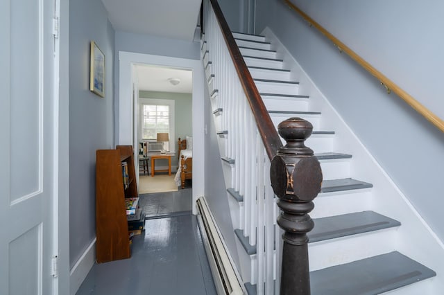 stairs with baseboard heating, cooling unit, and wood finished floors