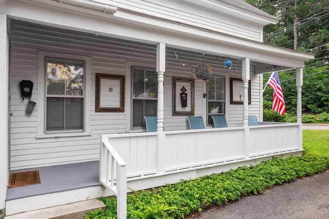 view of exterior entry with covered porch