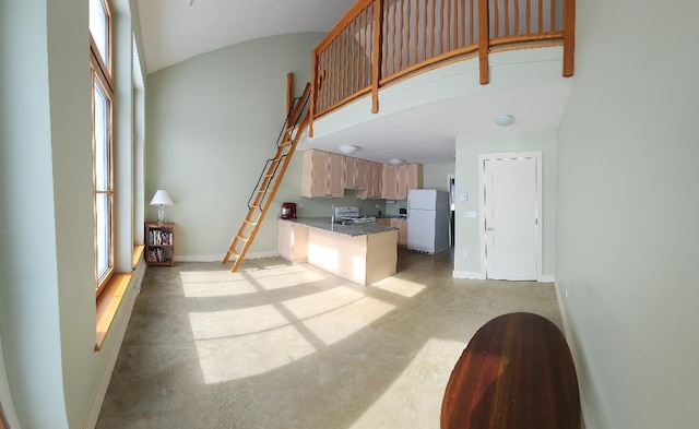 kitchen with baseboards, white appliances, and a high ceiling