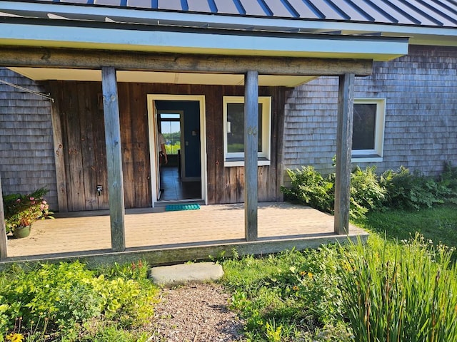 entrance to property featuring metal roof and a standing seam roof