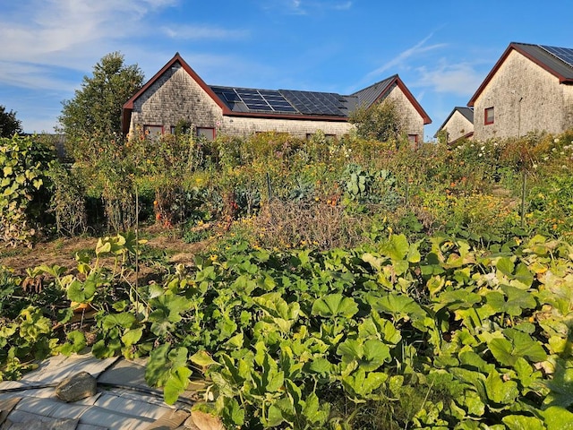 exterior space with solar panels and brick siding