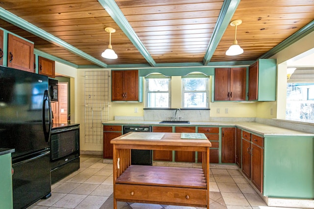 kitchen with light tile patterned floors, a sink, light countertops, beam ceiling, and black appliances