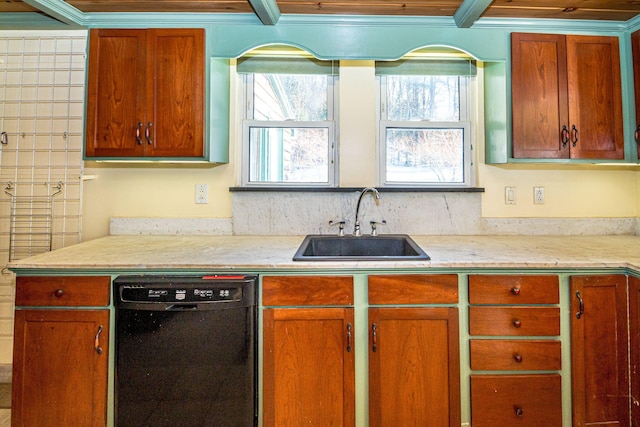 kitchen with brown cabinetry, black dishwasher, light countertops, and a sink