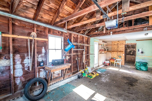 misc room with a garage and lofted ceiling