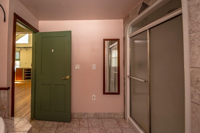 interior space with a shower with door