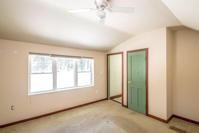 unfurnished bedroom featuring lofted ceiling, ceiling fan, and baseboards