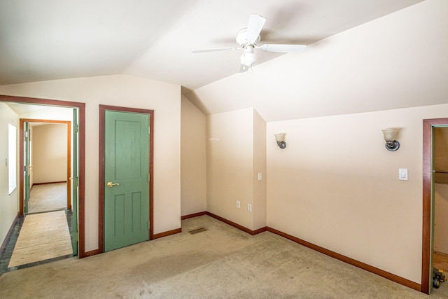 bonus room featuring baseboards, visible vents, a ceiling fan, vaulted ceiling, and carpet floors