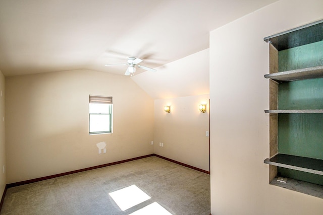 additional living space with carpet floors, vaulted ceiling, baseboards, and a ceiling fan