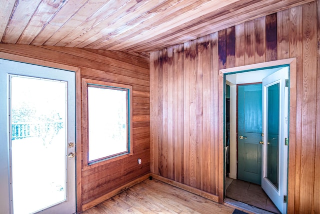 interior space featuring wooden ceiling, wood walls, and light wood-style flooring