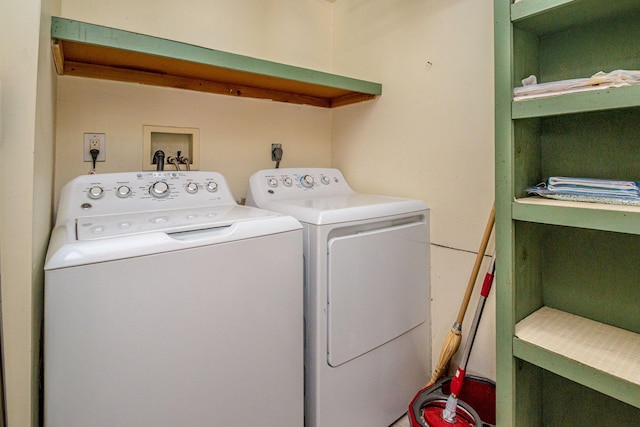 clothes washing area featuring laundry area and washer and clothes dryer