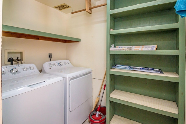 laundry area with washer and dryer, laundry area, and visible vents