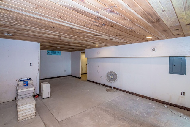 finished below grade area with wooden ceiling, electric panel, and baseboards