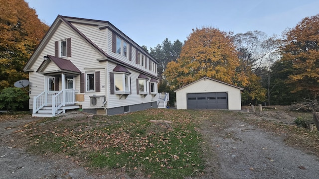 view of front facade with a garage, metal roof, and an outdoor structure