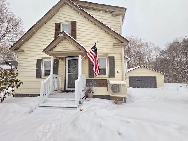 view of front of property with a garage, ac unit, and an outdoor structure