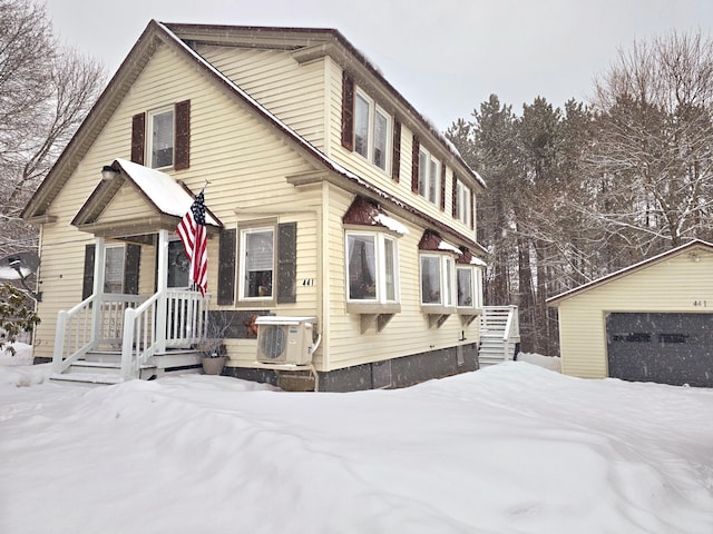 view of front facade featuring ac unit and an outbuilding