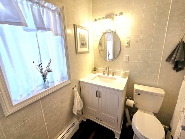 bathroom with toilet, a baseboard radiator, vanity, and tile walls