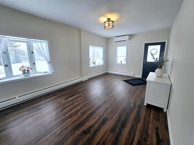 entrance foyer featuring a wall unit AC, dark wood-style floors, and baseboards