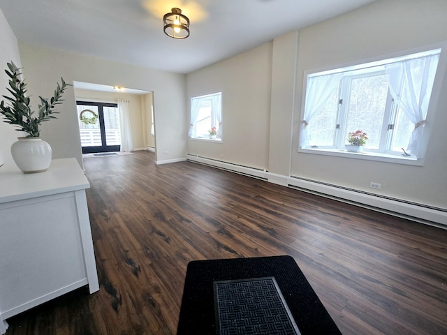 foyer with a baseboard radiator, dark wood finished floors, and baseboards