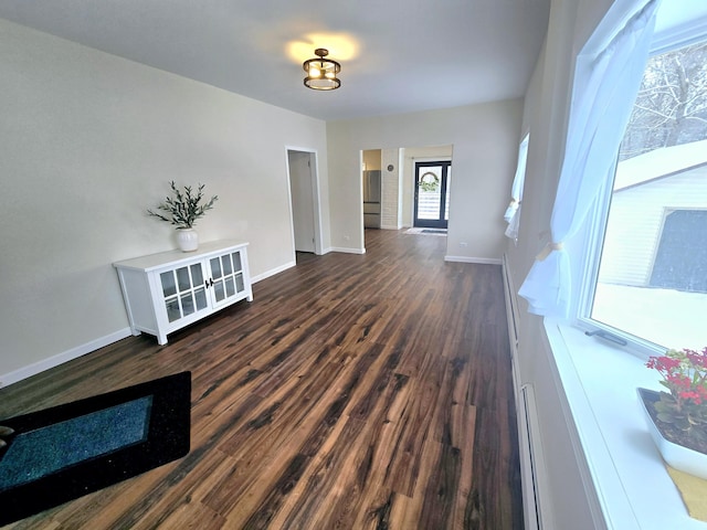 interior space with dark wood finished floors and baseboards