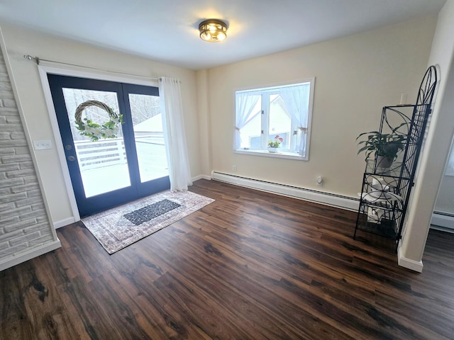 foyer entrance featuring baseboards, a healthy amount of sunlight, dark wood finished floors, and baseboard heating