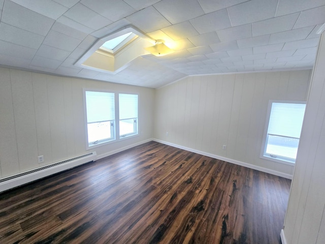 bonus room with vaulted ceiling, dark wood-type flooring, baseboard heating, and baseboards