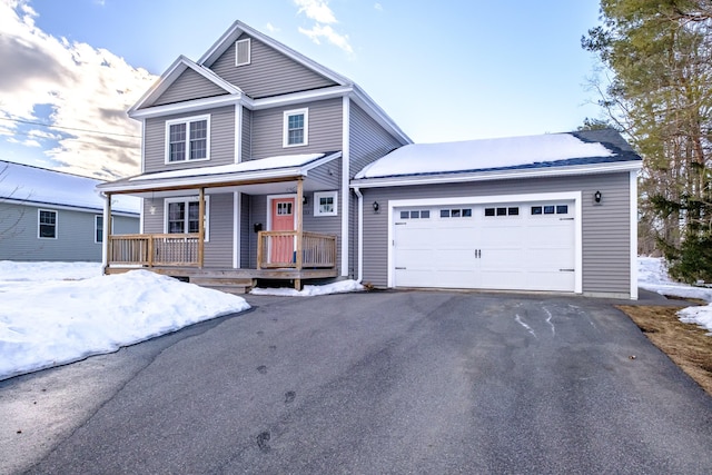 traditional home featuring driveway, a porch, and an attached garage