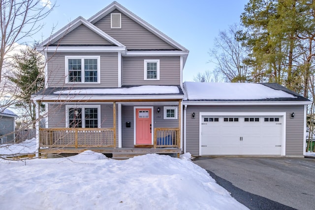 view of front facade with a garage, aphalt driveway, and a porch