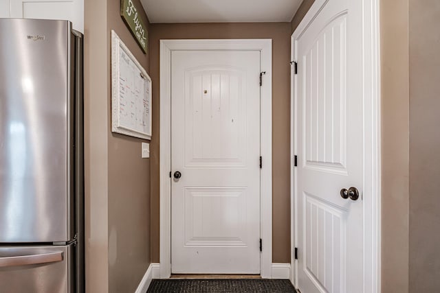 doorway featuring baseboards