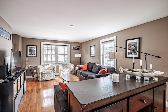 living area featuring light wood-type flooring and baseboards