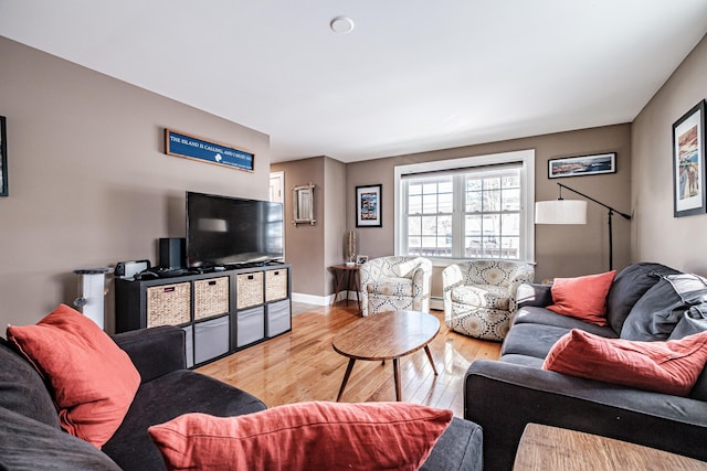 living room with wood finished floors and baseboards